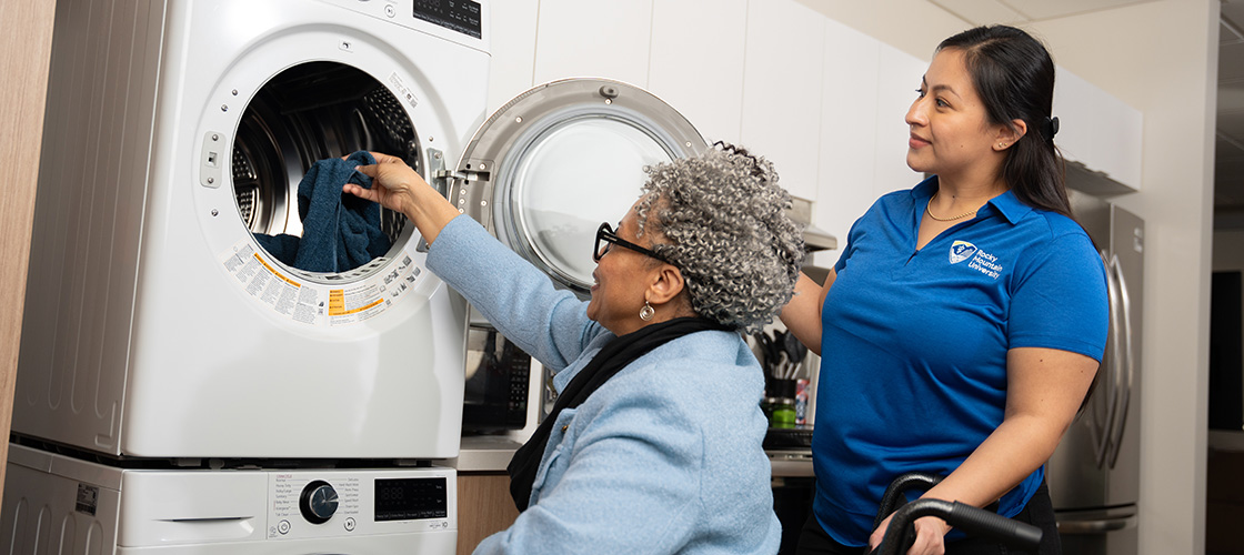 A woman learning to do laundry.
