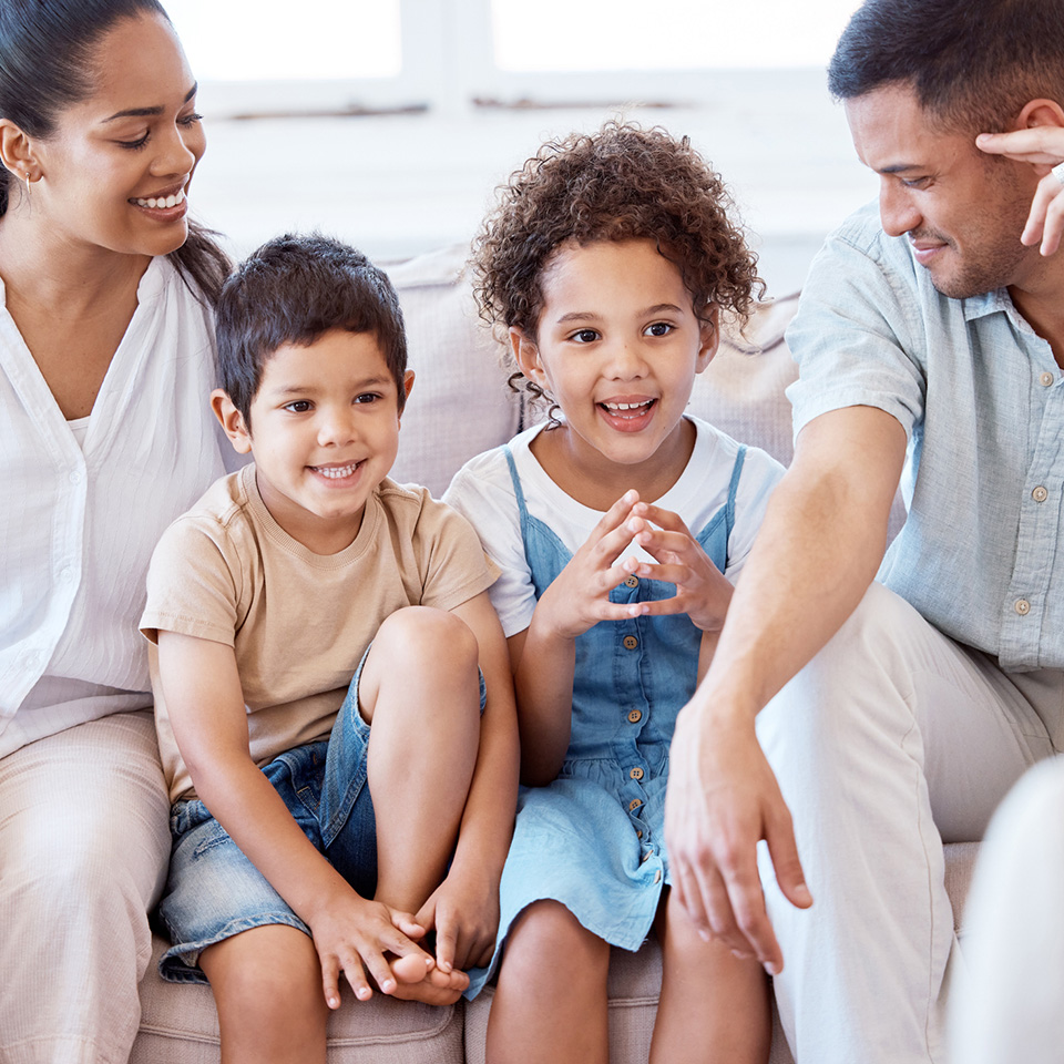a family sitting on a couch