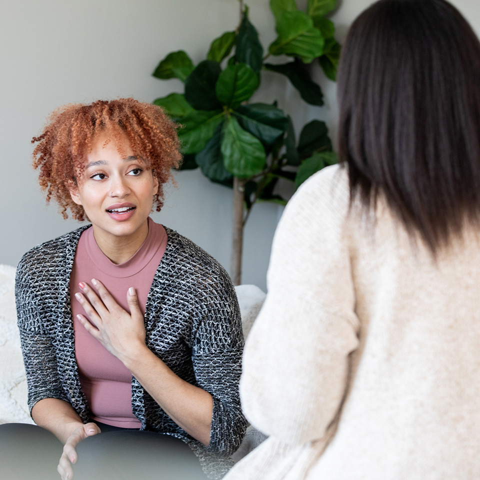 a woman talking to another woman