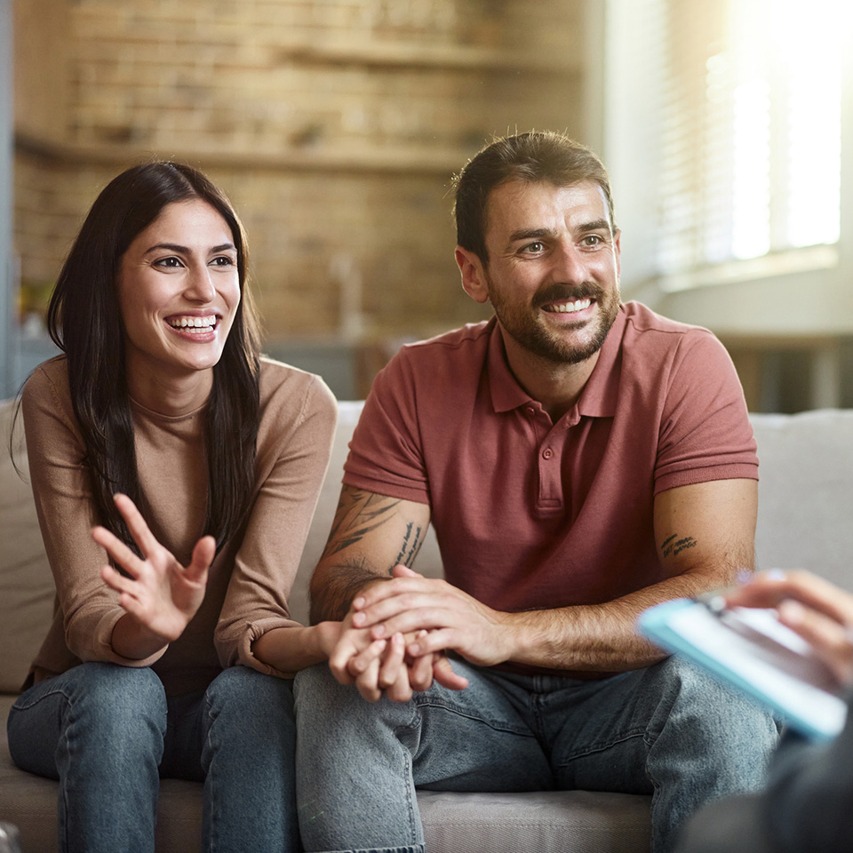 a man and woman sitting on a couch
